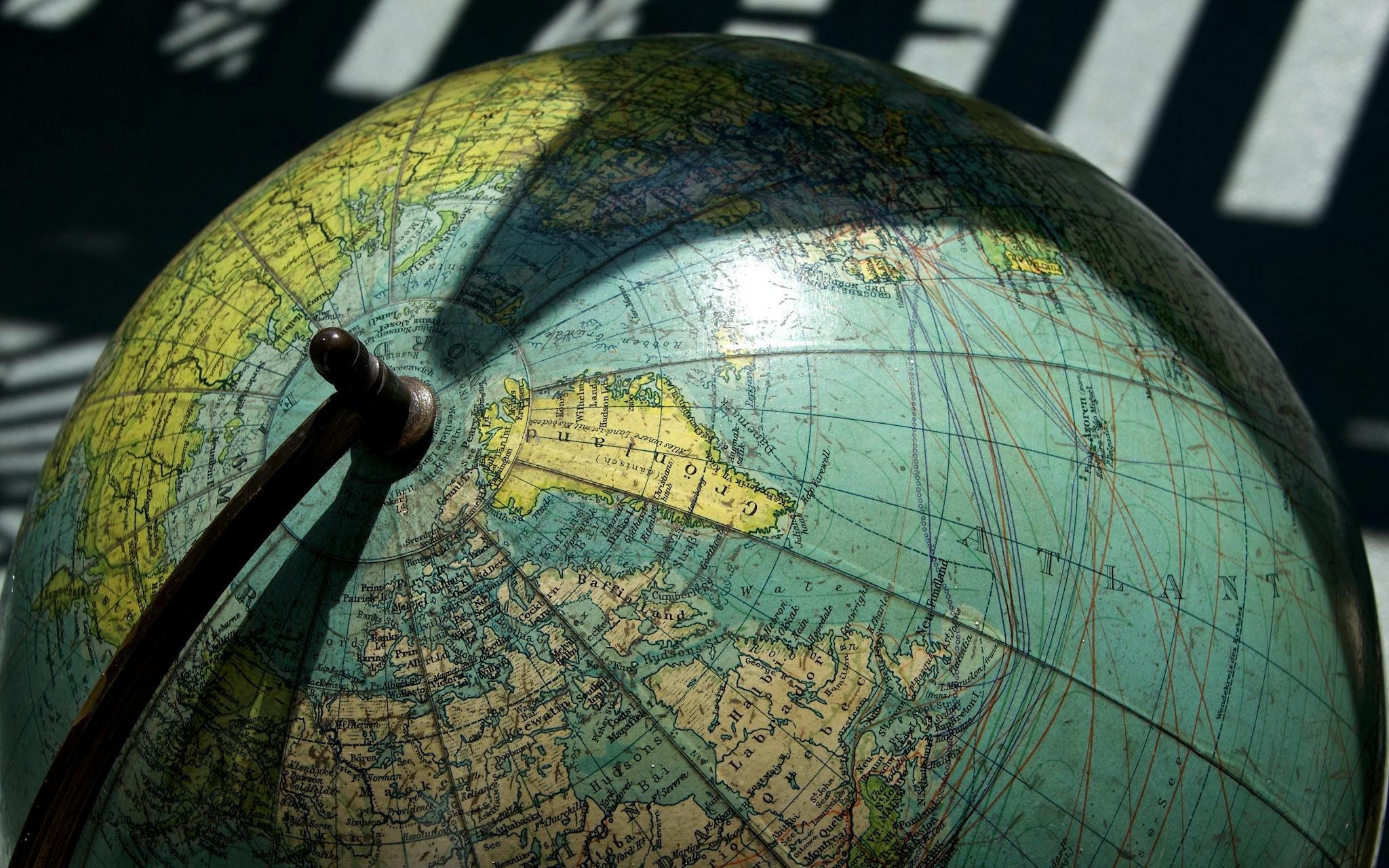 A detailed vintage globe showcasing northern regions with visible longitude and latitude lines.