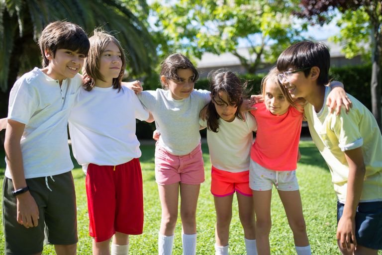 A joyful group of children playing outdoors, embodying friendship and happiness. Perfect lifestyle stock image.