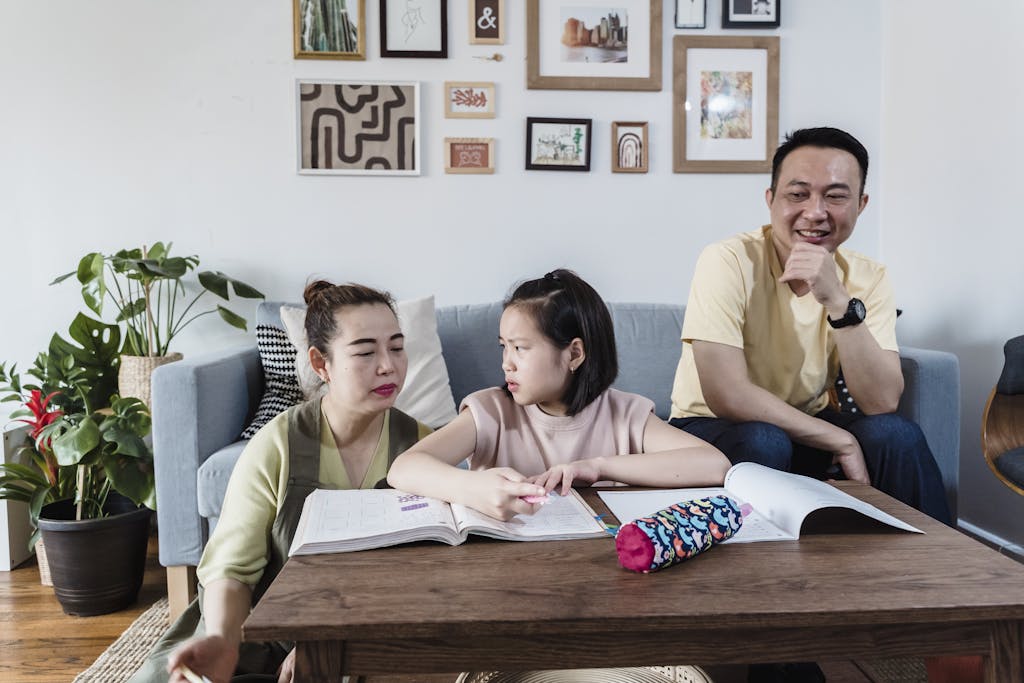 Family gathered in a cozy living room helping daughter with schoolwork. Warm and joyful ambiance.