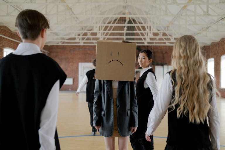 Students in a school gym highlighting themes of bullying and peer pressure.